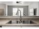 Close-up of a stainless steel kitchen sink with a modern faucet and neutral countertop at 9758 Laredo St # 37C, Commerce City, CO 80022
