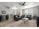 Bright living room featuring plush seating, a ceiling fan, and neutral decor, creating a cozy and inviting space at 9758 Laredo St # 37C, Commerce City, CO 80022