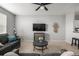 Cozy living room with neutral carpet, gray sofas, and sleek TV setup at 9758 Laredo St # 37C, Commerce City, CO 80022