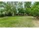 Spacious backyard with lush green grass and mature trees at 2212 S Naples Way, Aurora, CO 80013