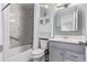 A bathroom is fully equipped with a bathtub, shower, toilet, and a sink with a mirror at 2212 S Naples Way, Aurora, CO 80013