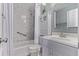 A bathroom is fully equipped with a bathtub, shower, toilet, and a sink with a mirror at 2212 S Naples Way, Aurora, CO 80013