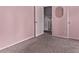 Inviting bedroom with soft pink walls, plush carpeting, and a closet, perfect for relaxation and comfort at 2212 S Naples Way, Aurora, CO 80013
