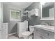 This modern laundry room includes a washing machine, toilet, sink, window and shelves at 2212 S Naples Way, Aurora, CO 80013