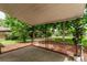 Covered patio with views of the serene, green landscaped backyard at 2212 S Naples Way, Aurora, CO 80013