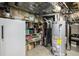 Unfinished basement area with water heater and storage shelving at 16321 Parkside Dr, Parker, CO 80134