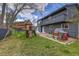 Expansive backyard with play area, including a swing set, playhouse, and trampoline at 8446 Lightening View Dr, Parker, CO 80134