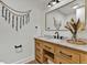 Stylish bathroom featuring a wooden vanity, marble countertop, modern fixtures, and decorative accents at 8446 Lightening View Dr, Parker, CO 80134