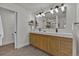 Luxurious bathroom featuring a double vanity, tile floors, modern fixtures, and a glass shower at 8446 Lightening View Dr, Parker, CO 80134