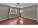 Charming bedroom with light gray walls, wood floors, and natural light from large windows at 8446 Lightening View Dr, Parker, CO 80134