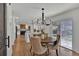 Open-concept dining area with a modern chandelier and seamless access to the kitchen at 8446 Lightening View Dr, Parker, CO 80134