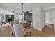 Elegant dining area open to the living room, featuring a modern chandelier and sliding barn door at 8446 Lightening View Dr, Parker, CO 80134