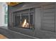 Close-up of a sleek fireplace with a metal screen and stylish gray tile surround at 8446 Lightening View Dr, Parker, CO 80134