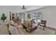 Bright, open living room featuring a seamless flow to the dining and kitchen areas at 8446 Lightening View Dr, Parker, CO 80134