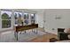 This is a home office with a wood desk, office chair, and large windows that overlook the backyard at 8446 Lightening View Dr, Parker, CO 80134