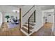 Bright staircase with a modern black metal railing leading to the second floor at 8446 Lightening View Dr, Parker, CO 80134