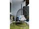 Cozy balcony features a hanging swing chair, potted plants, and faux grass at 2460 W 29Th Ave # 104, Denver, CO 80211