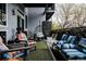 Inviting covered balcony with plush seating, a hanging chair, and stylish decor at 2460 W 29Th Ave # 104, Denver, CO 80211