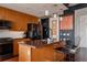Stylish kitchen with island, wood cabinets, and modern appliances at 2460 W 29Th Ave # 104, Denver, CO 80211