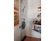 Functional laundry area features stacked washer/dryer and convenient shelving for storage at 2460 W 29Th Ave # 104, Denver, CO 80211