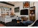 Bright living room features a gray sofa, unique decor, and dark plush rug at 2460 W 29Th Ave # 104, Denver, CO 80211