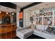 Open-concept living room with gray sectional, shelving and hardwood floors at 2460 W 29Th Ave # 104, Denver, CO 80211