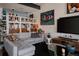 Comfortable living room with sectional sofa, playful artwork, and curated shelving at 2460 W 29Th Ave # 104, Denver, CO 80211