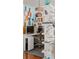 Creative office space with open shelving, modern desk, and unique decorative items at 2460 W 29Th Ave # 104, Denver, CO 80211