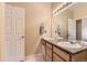 Clean bathroom with double sinks and a large mirror at 9569 Pearl Cir # 204, Parker, CO 80134