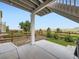Covered back patio with a wooden fence and view of the surrounding neighborhood at 18280 W 85Th Dr, Arvada, CO 80007
