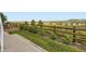 Fenced-in backyard with green grass and mature landscaping offers privacy and a safe space for outdoor activities at 18280 W 85Th Dr, Arvada, CO 80007