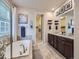 Relaxing bathroom showcases a soaking tub, granite countertops, double sinks, and a walk-in closet at 18280 W 85Th Dr, Arvada, CO 80007