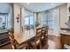 Bright dining room features hardwood floors, natural light from sliding glass doors, and a large wooden table at 18280 W 85Th Dr, Arvada, CO 80007
