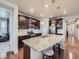 Spacious kitchen with granite countertops, stainless steel appliances, and an island with barstool seating at 18280 W 85Th Dr, Arvada, CO 80007