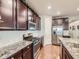 Gourmet kitchen with stainless steel appliances, granite countertops, and ample cabinet space at 18280 W 85Th Dr, Arvada, CO 80007