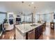 Open concept kitchen with large center island, pendant lighting, and stainless steel appliances at 18280 W 85Th Dr, Arvada, CO 80007