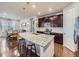 Spacious kitchen with granite countertops, stainless steel appliances, and an island with barstool seating at 18280 W 85Th Dr, Arvada, CO 80007