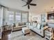 Bright living room with large windows, a neutral color palette, and an open floor plan at 18280 W 85Th Dr, Arvada, CO 80007