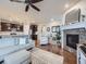 Cozy living room with a fireplace, comfortable seating, and an open view to the kitchen at 18280 W 85Th Dr, Arvada, CO 80007