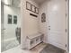 Welcoming mudroom entry with a cushioned bench and access to laundry room at 18280 W 85Th Dr, Arvada, CO 80007