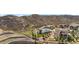 Aerial view of a home with a backyard featuring a patio and firepit area, surrounded by hills at 2065 Sage Grouse Way, Castle Rock, CO 80109