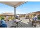 Relaxing deck area with comfortable seating, glass coffee table and stunning mountain views at 2065 Sage Grouse Way, Castle Rock, CO 80109