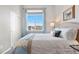 Cozy bedroom with a large window offering scenic views and ample natural light at 2065 Sage Grouse Way, Castle Rock, CO 80109