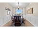 Elegant dining room featuring wainscoting, a scenic view, and a classic chandelier at 2065 Sage Grouse Way, Castle Rock, CO 80109