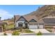 Charming two-story home features a three-car garage and beautifully landscaped front yard with mountain views at 2065 Sage Grouse Way, Castle Rock, CO 80109