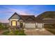 Exterior front view of home with a three car garage and well manicured front yard at 2065 Sage Grouse Way, Castle Rock, CO 80109