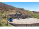 Outdoor fire pit area with stone seating and beautiful landscaping on a sunny day at 2065 Sage Grouse Way, Castle Rock, CO 80109