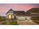 Stylish home with stone accents, a three-car garage, and a well-maintained front yard against a scenic backdrop at 2065 Sage Grouse Way, Castle Rock, CO 80109