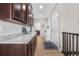 Hallway with wood floors leads to a hallway bench and coat rack, connecting the kitchen area to the home's entrance at 2065 Sage Grouse Way, Castle Rock, CO 80109