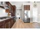 Modern kitchen with stainless steel appliances, dark wood cabinets, and hardwood floors at 2065 Sage Grouse Way, Castle Rock, CO 80109